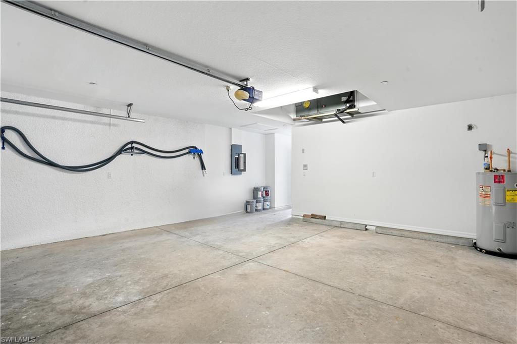 Spacious garage featuring concrete flooring and textured white walls