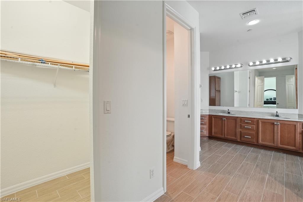 Spacious bathroom featuring an extended double vanity with undermount sinks and a large mirror
