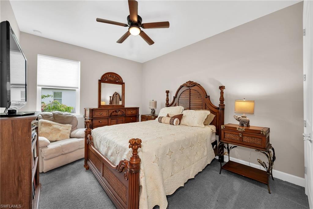 Bedroom featuring light gray wall paint and gray carpeting