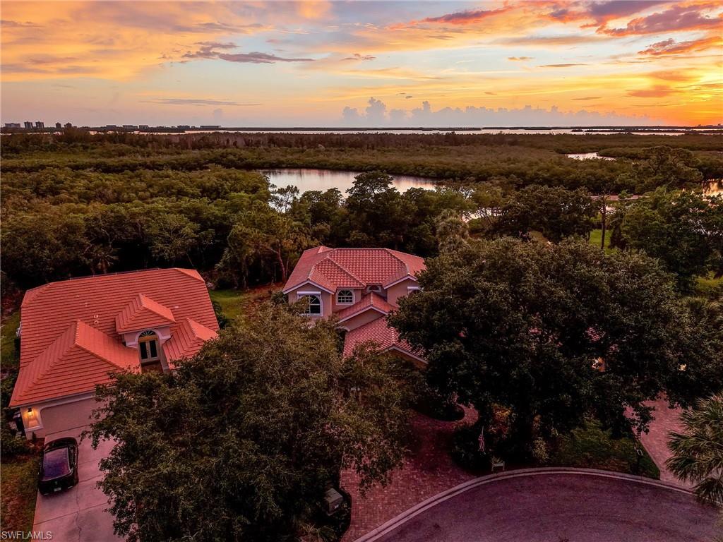 Aerial perspective showcasing the property's red tile roof and surrounding lush foliage