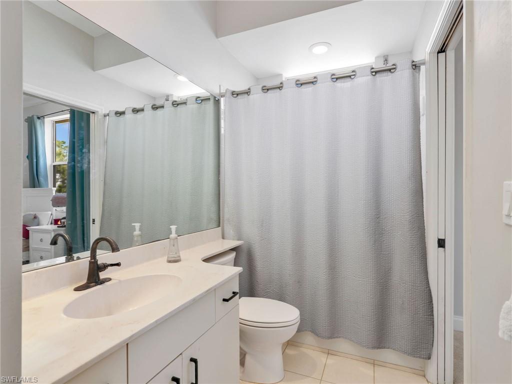 Bathroom featuring a vanity with an integrated sink, a dark bronze faucet, and a large mirror