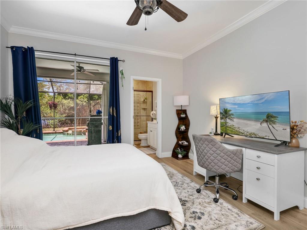 Sliding glass doors opening to an outdoor pool area, crown molding, wood-finish flooring, a ceiling fan, and an en-suite bathroom with a tiled shower