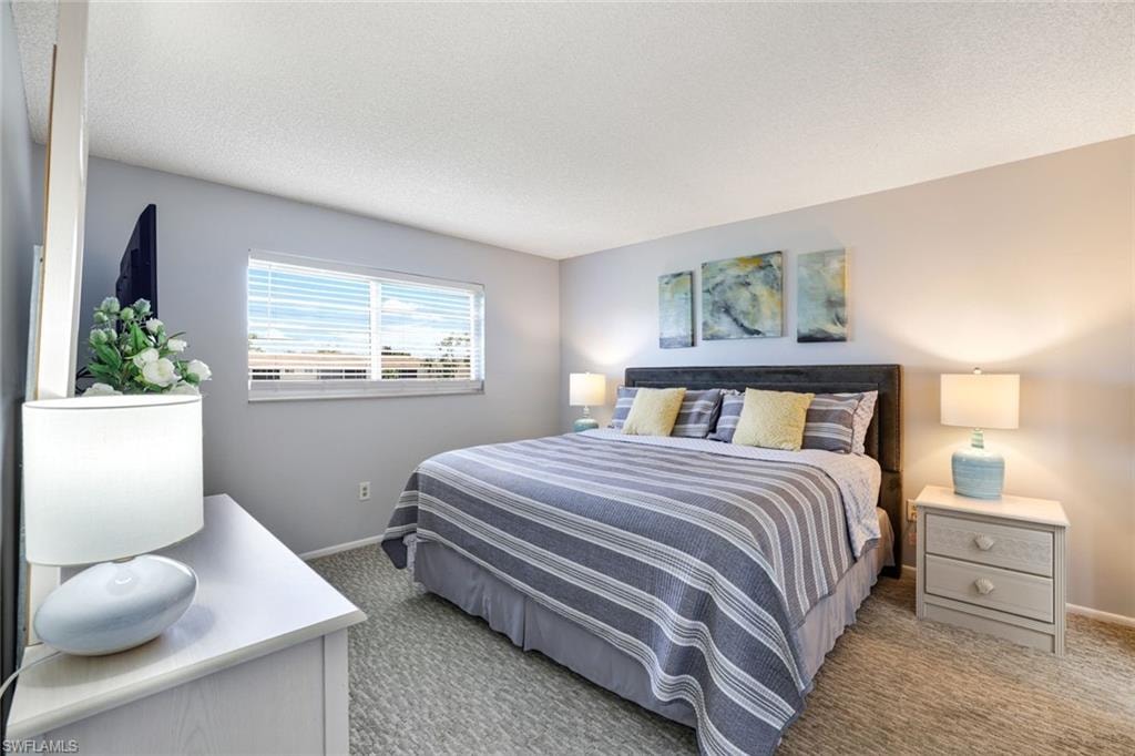 Bedroom with carpet floors and a textured ceiling