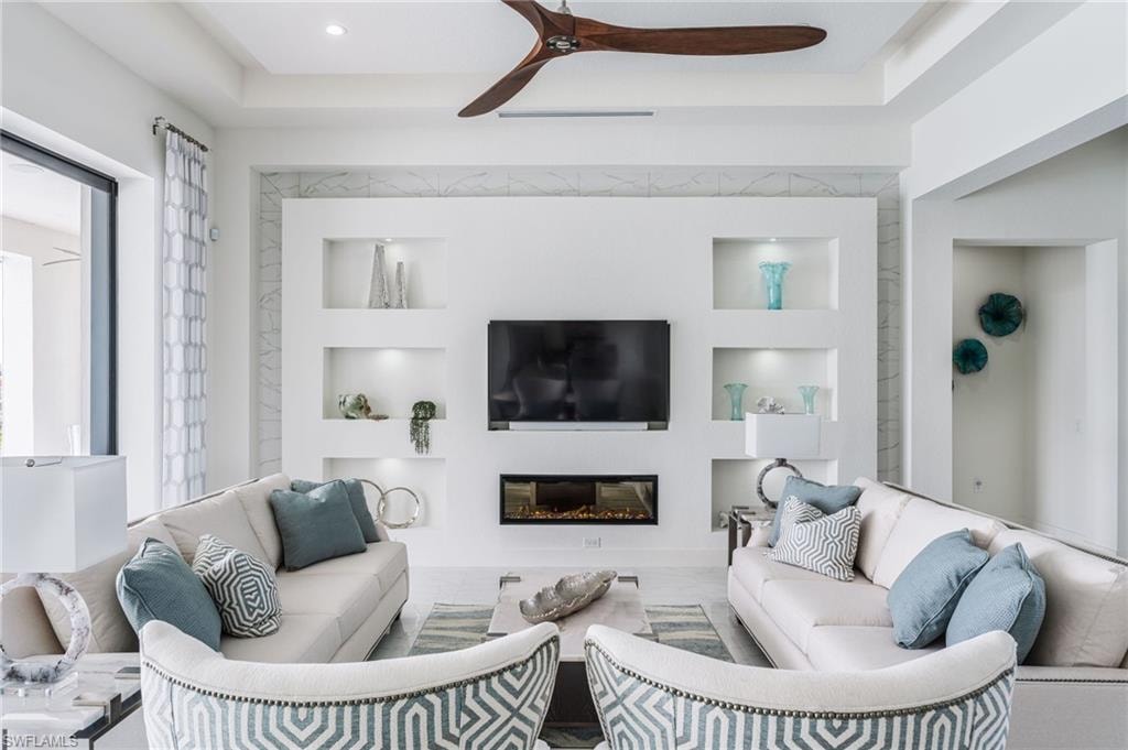 Built-in media wall with integrated shelving and an electric fireplace