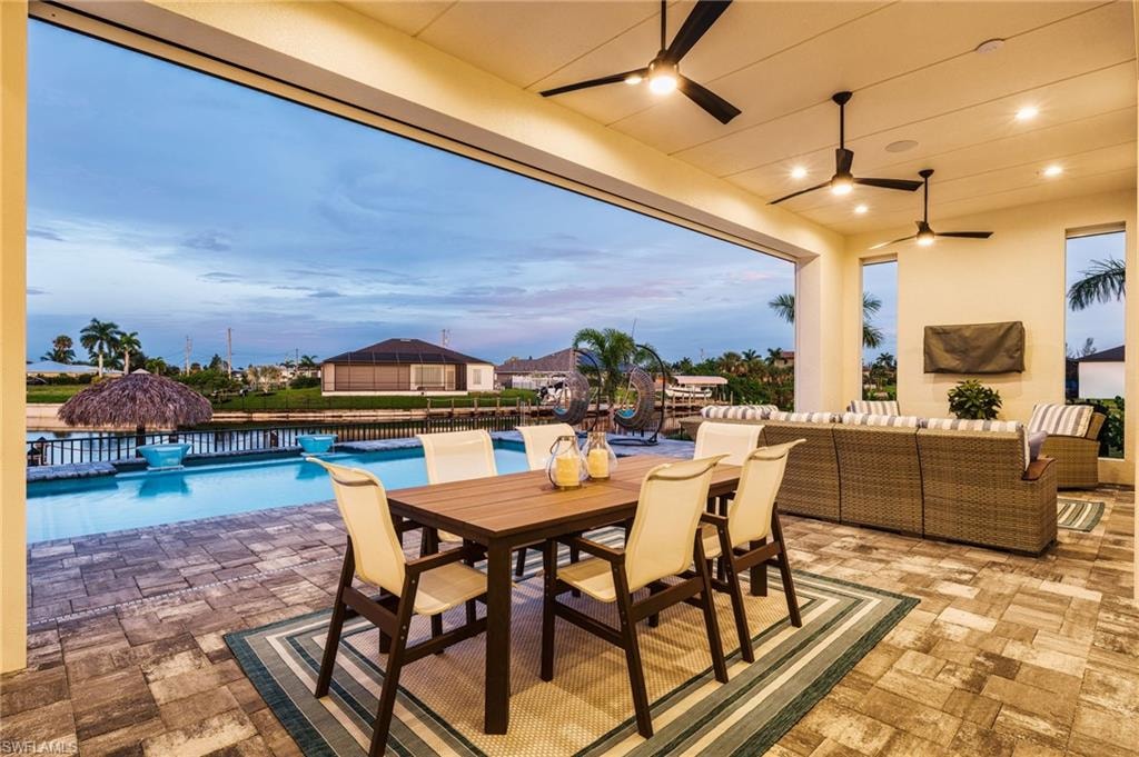 Expansive covered patio featuring patterned paver flooring and recessed lighting