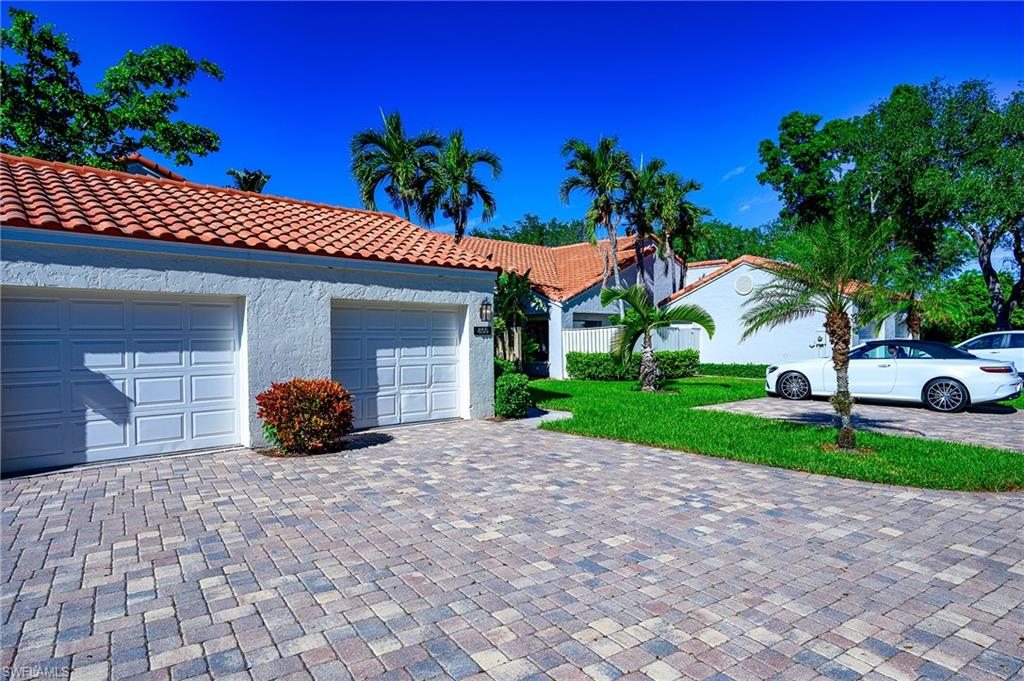 View of front facade featuring a garage and a front yard