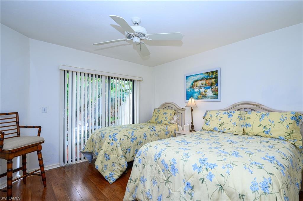 Bedroom featuring dark hardwood / wood-style flooring and ceiling fan