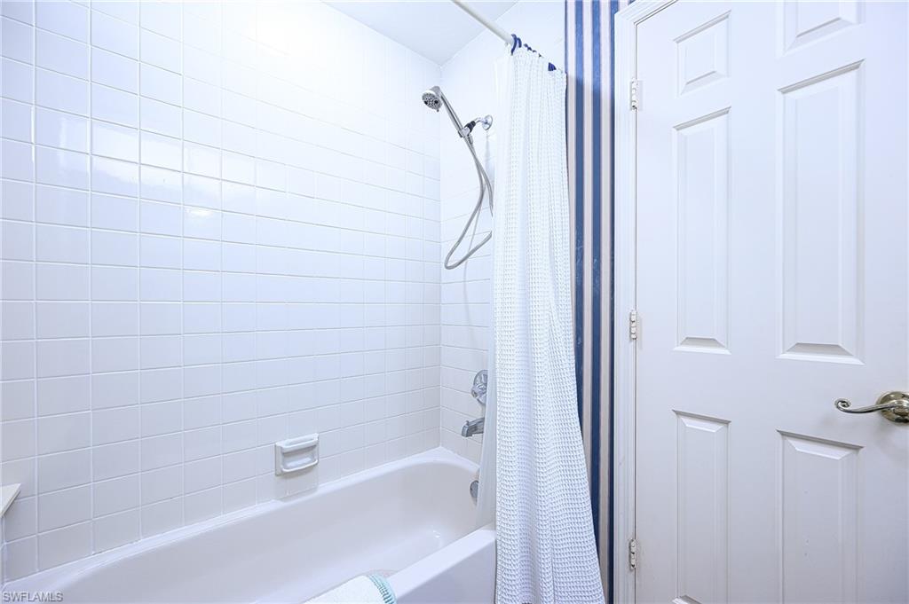 Bathroom featuring shower / bathtub combination with curtain