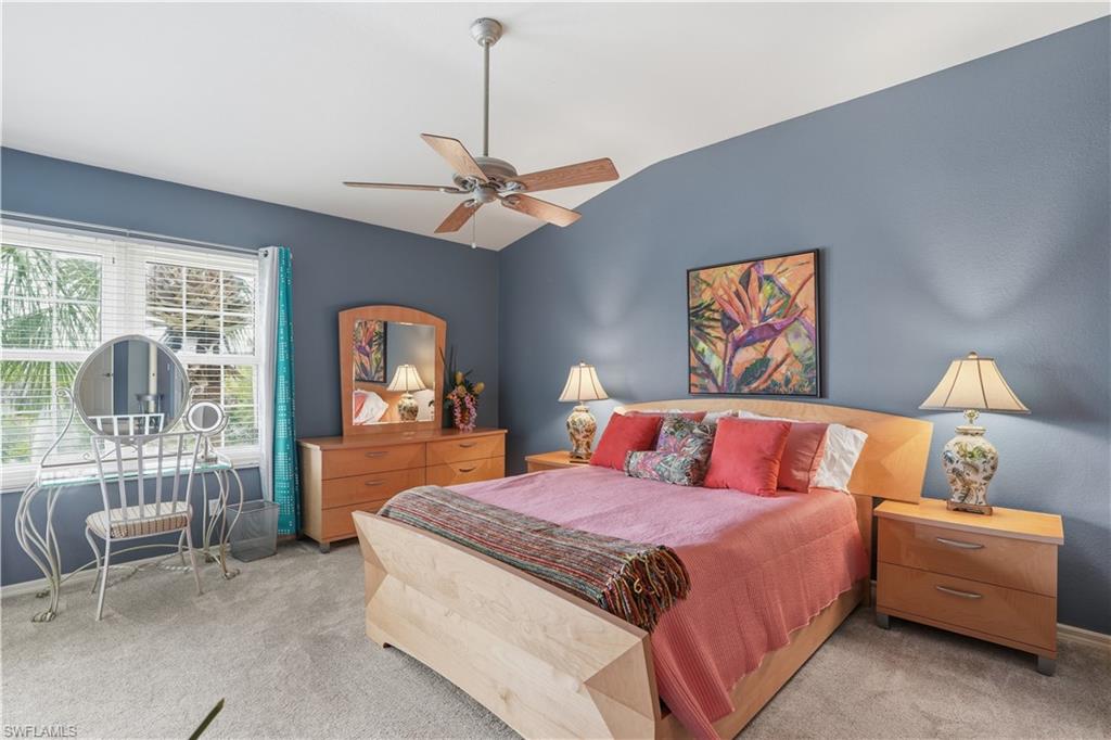 Spacious primary bedroom featuring vaulted ceilings and abundant natural light.