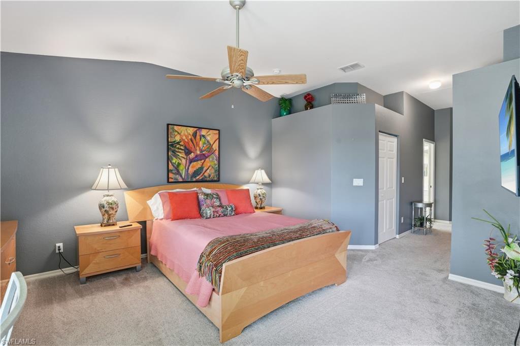 Additional view of the primary bedroom showcasing its spacious layout and vaulted ceilings.