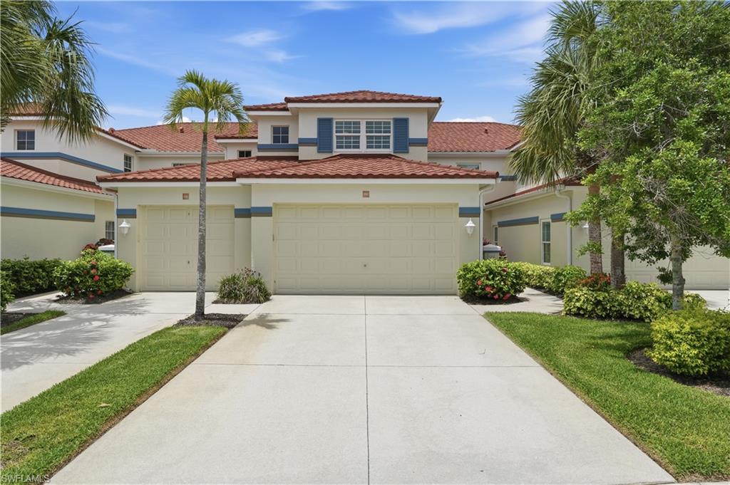 Attached two-car garage and manicured landscaping.