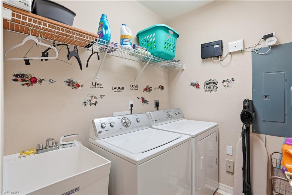 Convenient laundry room with utility sink and additional storage space.
