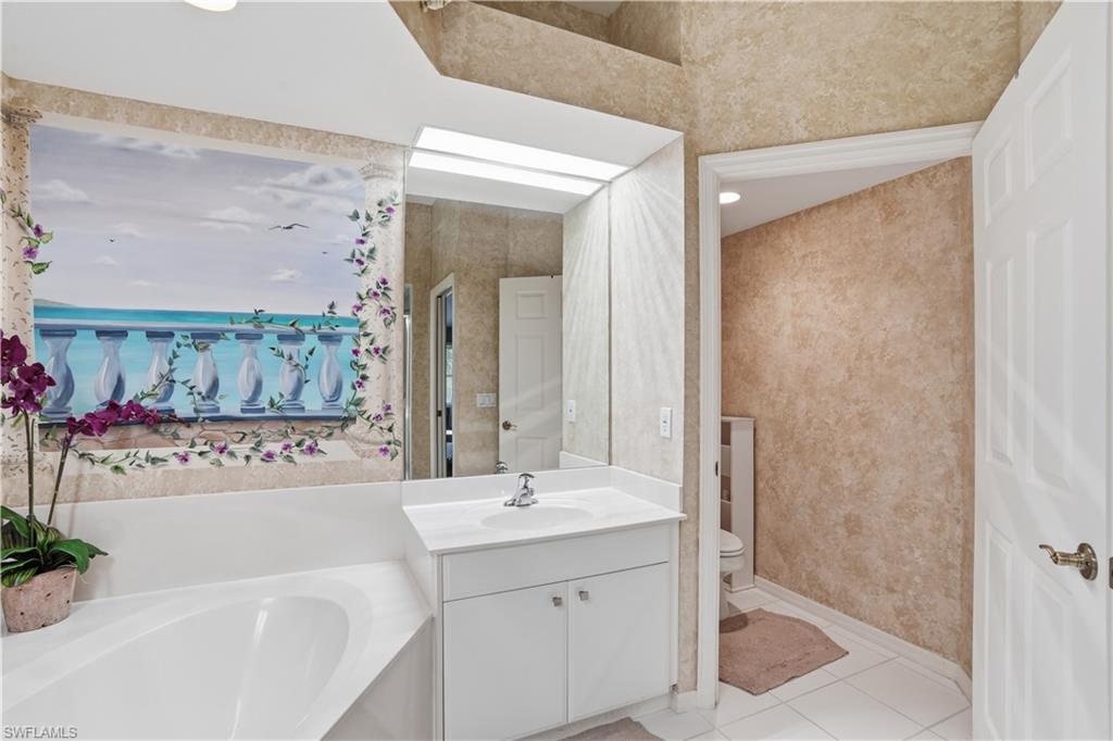 The primary bathroom offers two sink areas, a soaking tub, walk in shower and a private water closet.