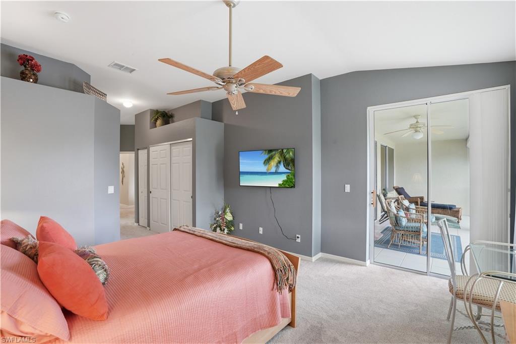 Primary bedroom with vaulted ceilings and access to the lanai.