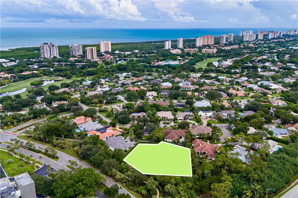 Build your dream multi-generational compound on a private cul-de-sac lot offering an acre of exceptional privacy in coveted Pelican Bay in Naples