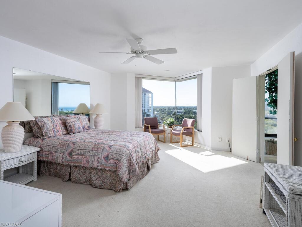 Carpeted bedroom featuring ceiling fan
