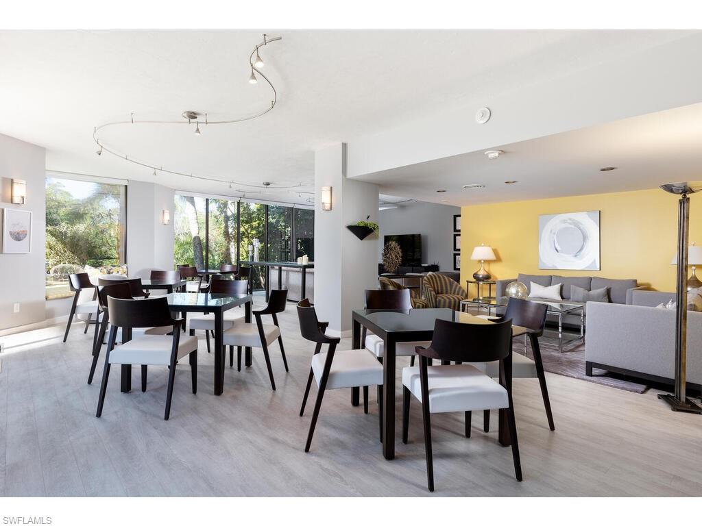 Dining space featuring a wall of windows and light hardwood / wood-style floors