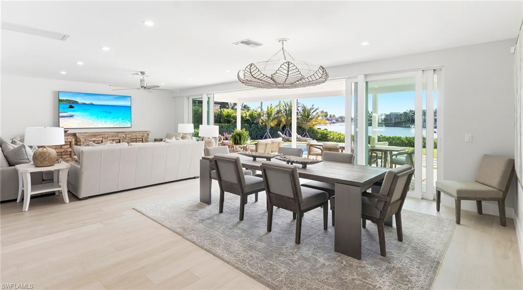 Dining area featuring a water view, recessed lighting, light wood-type flooring, and a ceiling fan