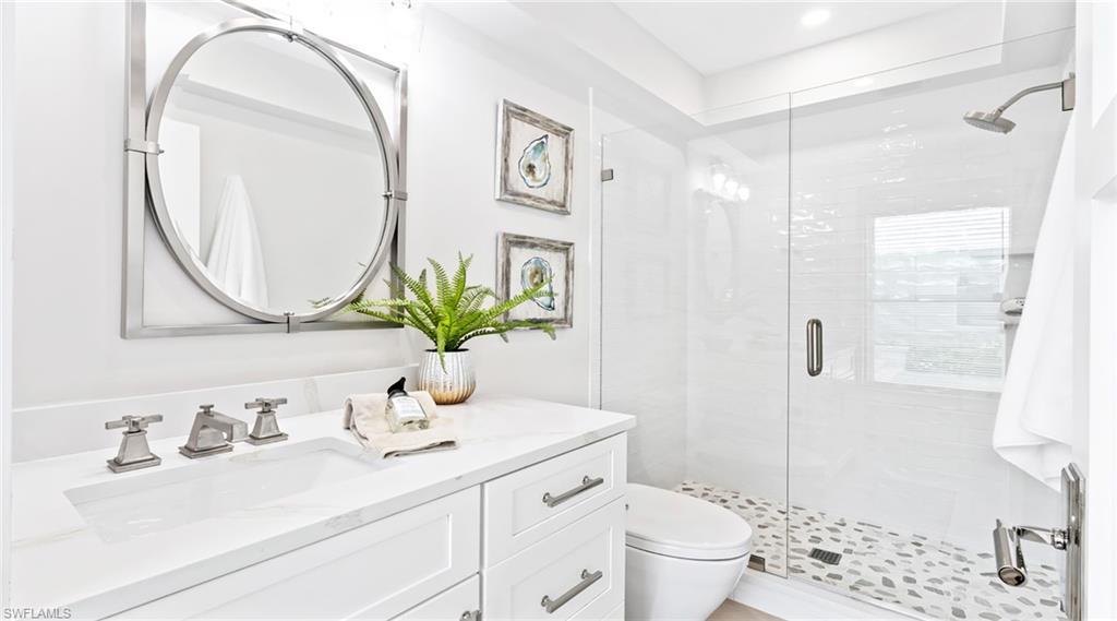 Bathroom with a stall shower and vanity