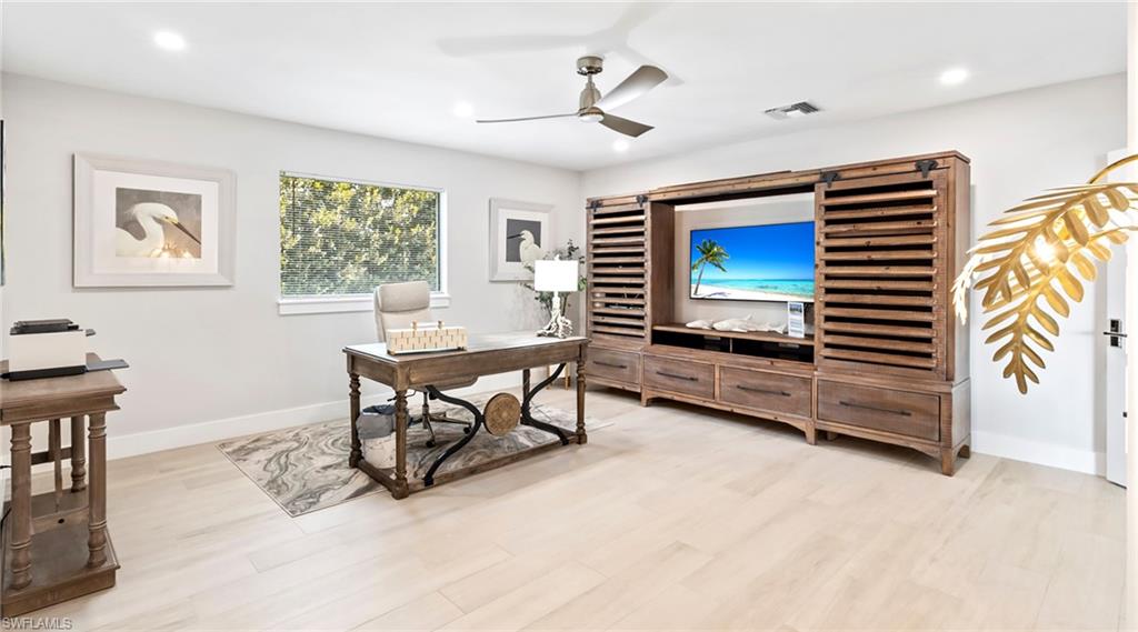 Office space with light wood-style flooring, a ceiling fan, and recessed lighting