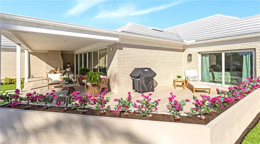 View of patio featuring a grill