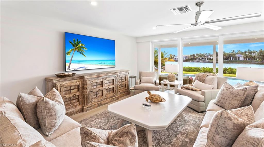Living area with a ceiling fan and wood finished floors