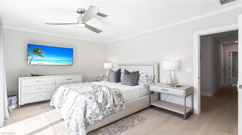 Bedroom with ornamental molding, ceiling fan, and wood finished floors