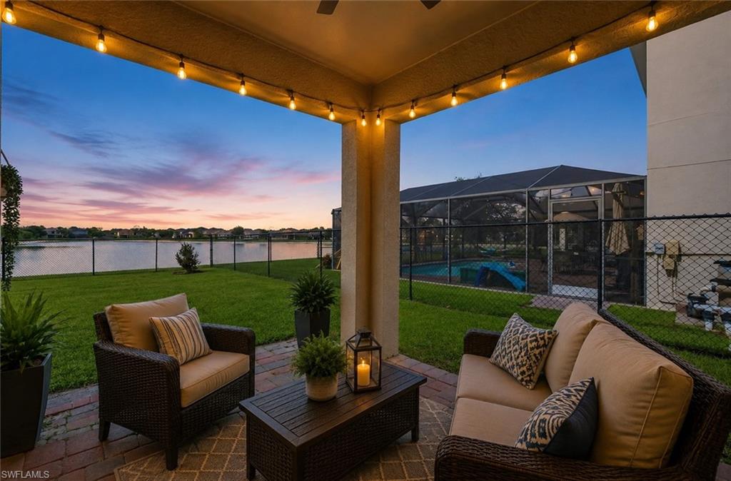 Covered patio featuring brick paver flooring and string lighting