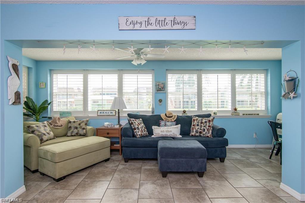 Bright enclosed sunroom offers flexible space for relaxing, reading, or a home office.