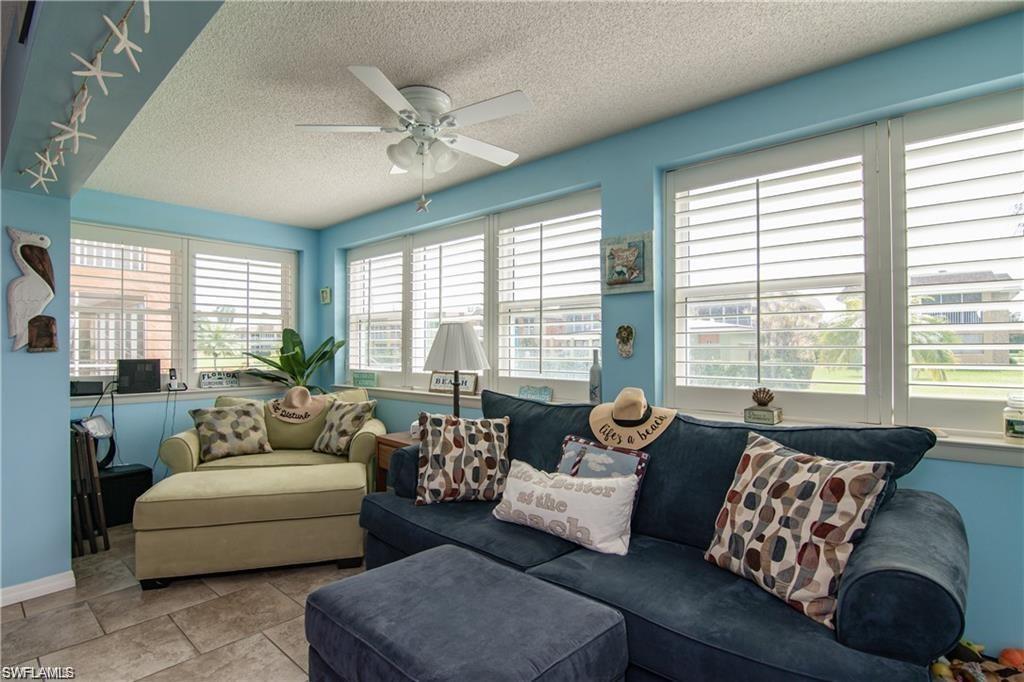 Enclosed sunroom with expansive windows overlooking the community.