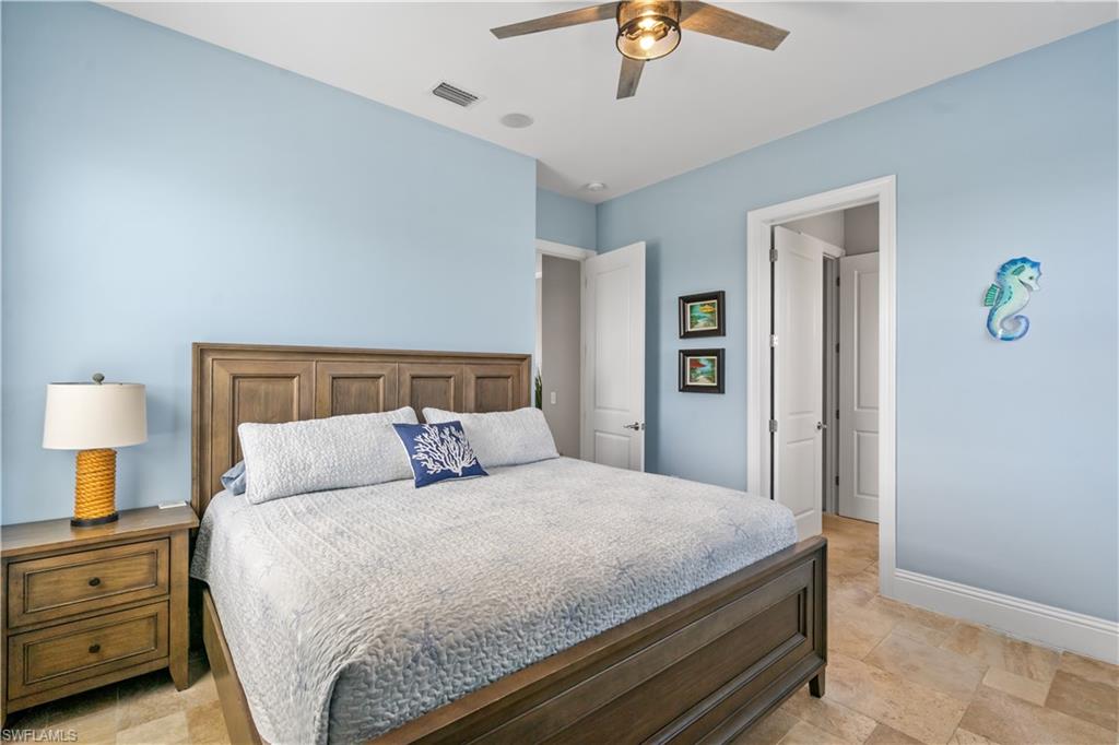 Bedroom featuring light blue walls and neutral tile flooring