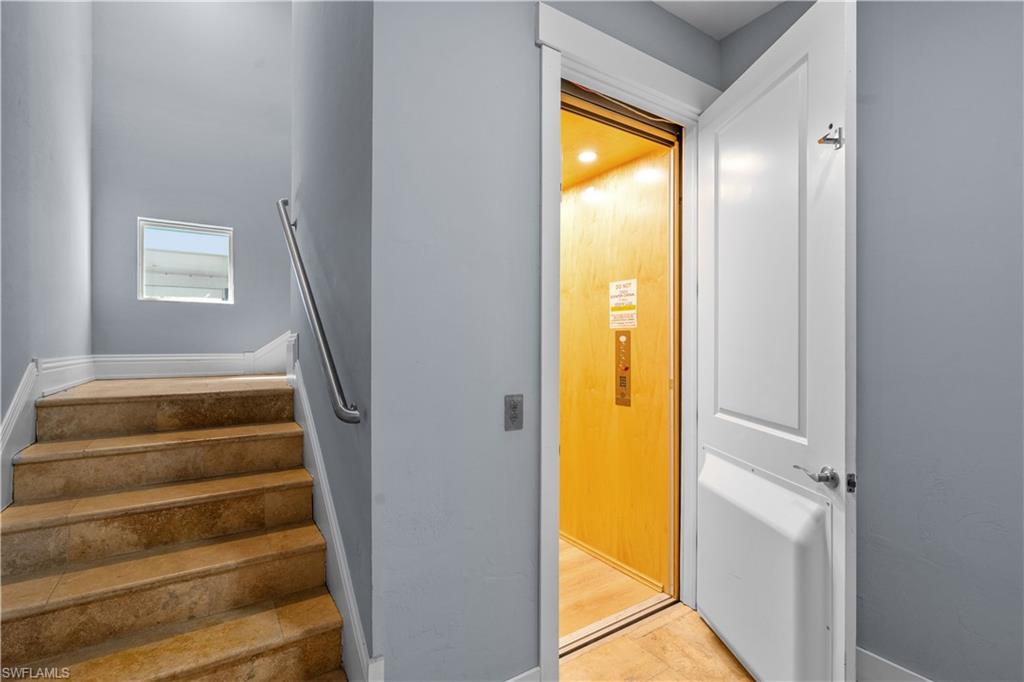 Interior elevator with a wood-paneled cabin and recessed lighting