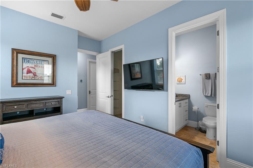 Bedroom featuring light blue walls and a ceiling fan