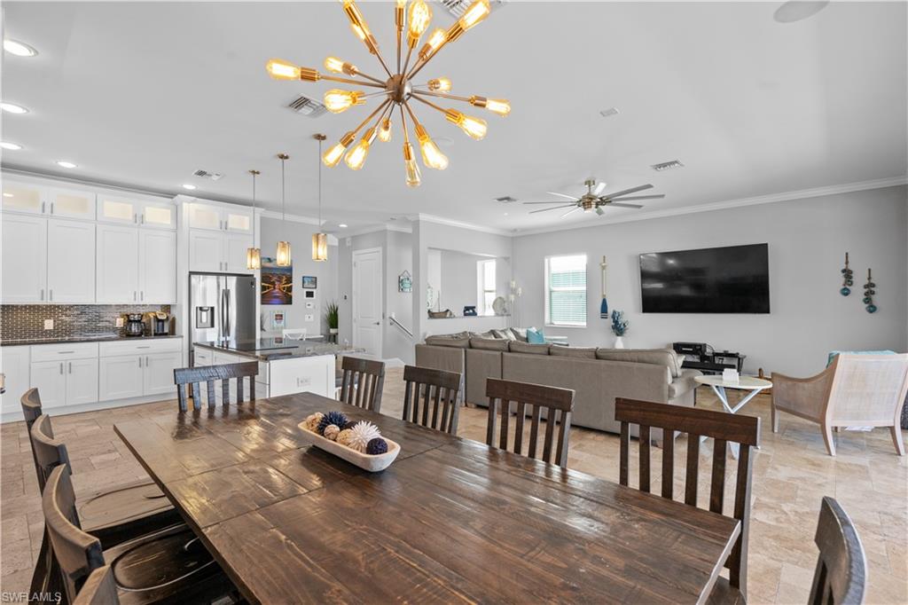 Open-concept living space featuring a dining area, kitchen, and living room with tile flooring