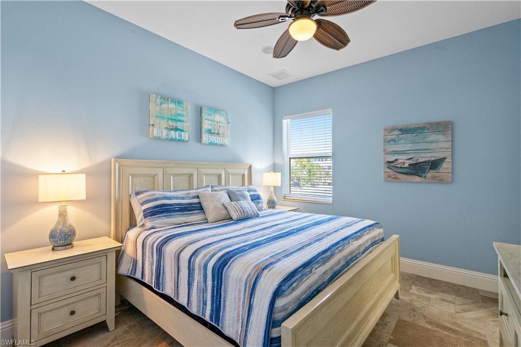 Bedroom featuring a ceiling fan with integrated lighting, a window with blinds, and tile flooring