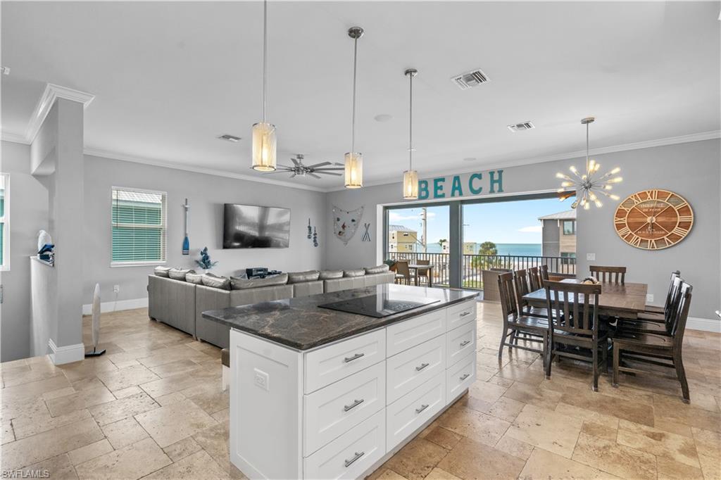 Spacious open-concept interior featuring light-toned tile flooring throughout