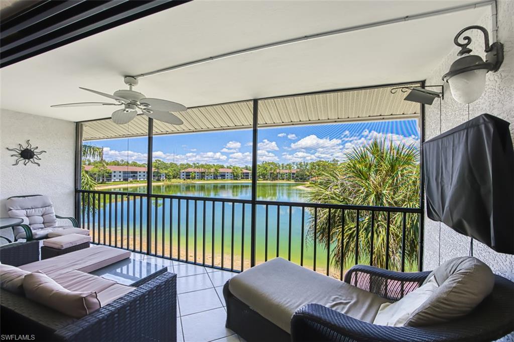 View of patio / terrace featuring a ceiling fan, a water view, a balcony, and outdoor lounge area