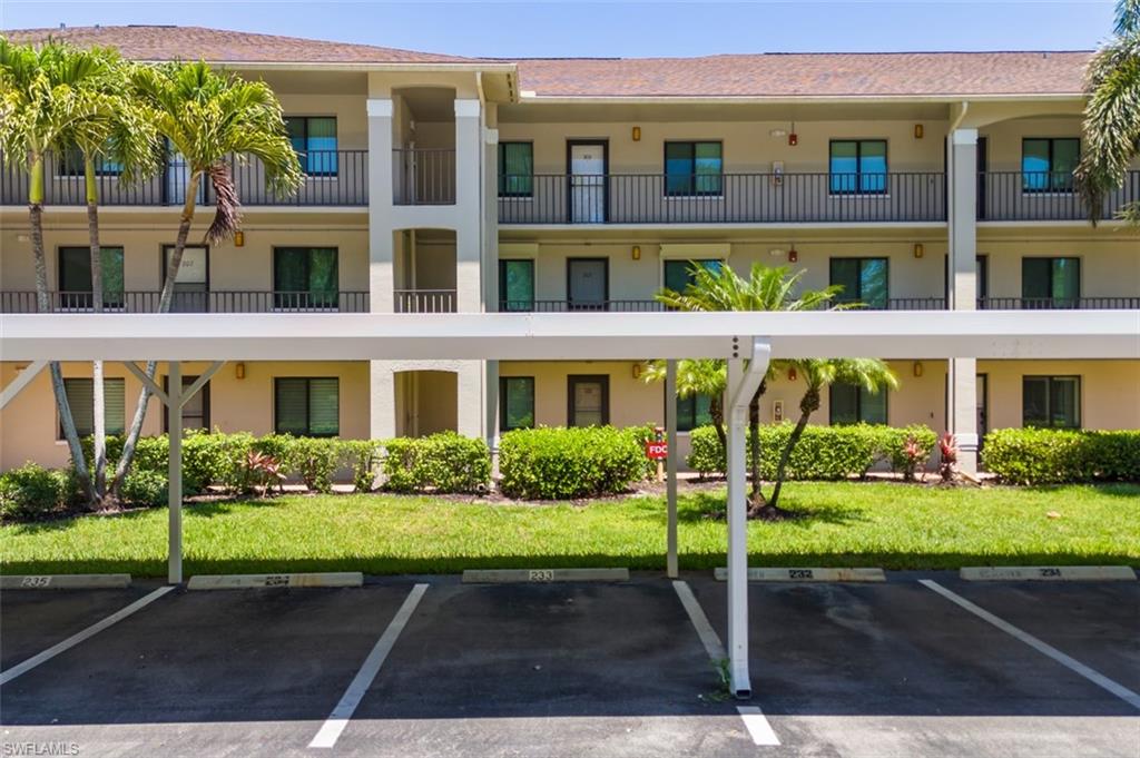 View of property with covered parking