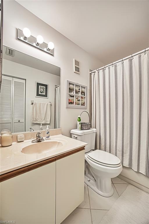 Bathroom with marble finish flooring, toilet, and vanity