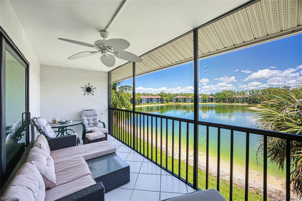 Balcony featuring a ceiling fan, a water view, and an outdoor living space