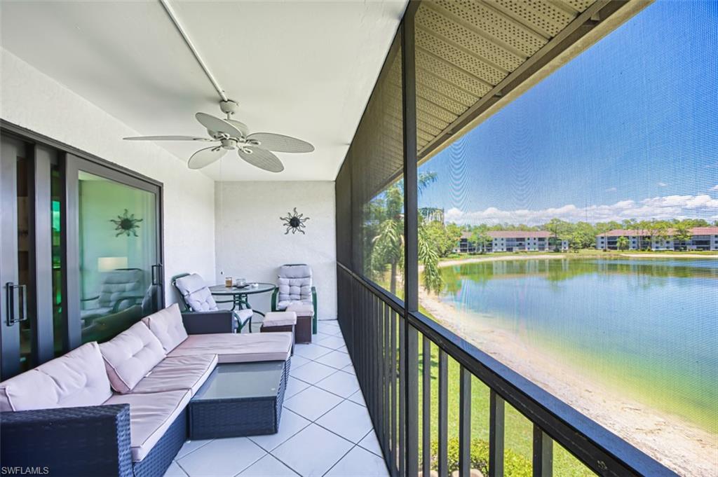 Balcony featuring an outdoor living space, a ceiling fan, and a water view
