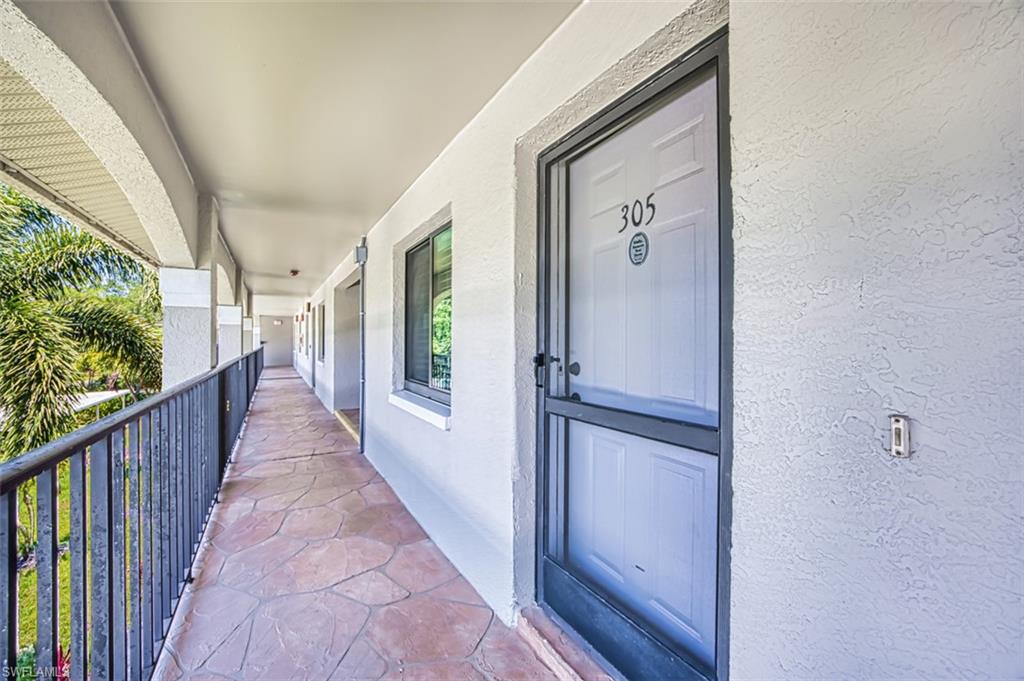 Doorway to property featuring stucco siding