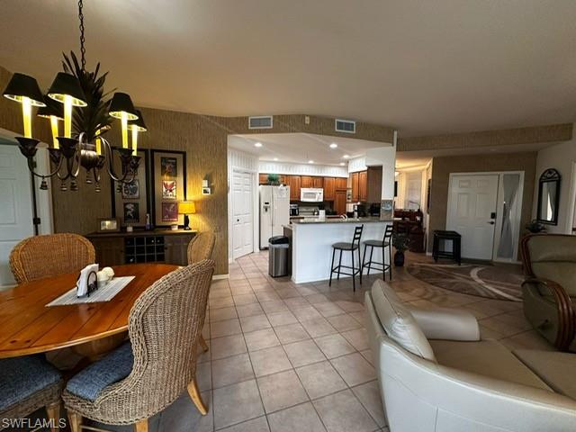 Dining area with visible vents and light tile patterned floors