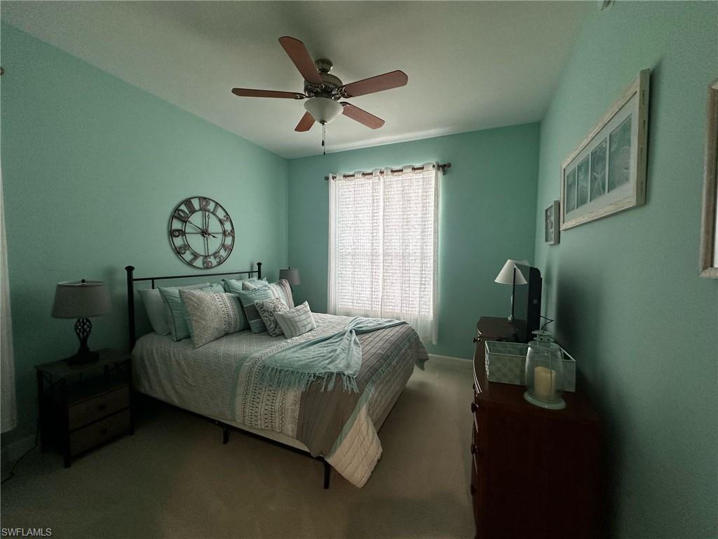 Bedroom with ceiling fan and carpet flooring