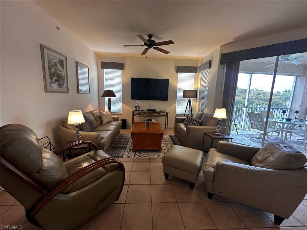 Living room featuring plenty of natural light, ceiling fan, and light tile patterned floors
