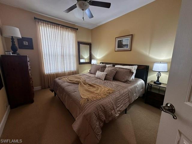Carpeted bedroom with baseboards and ceiling fan
