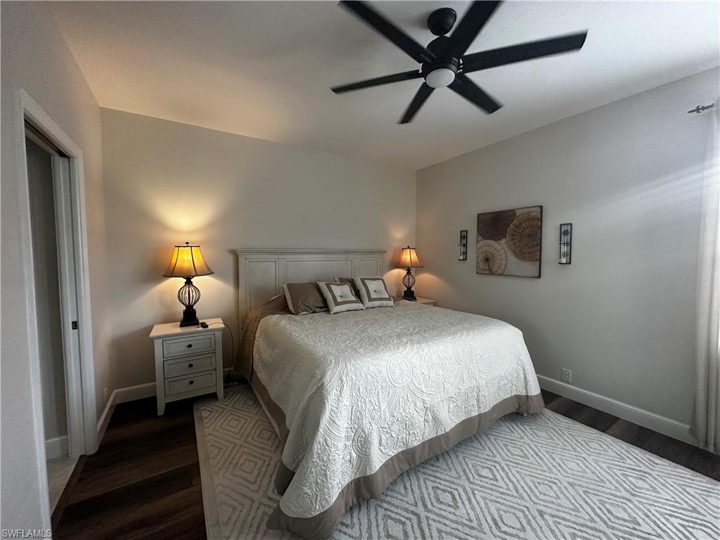 Bedroom featuring baseboards, a ceiling fan, and wood finished floors