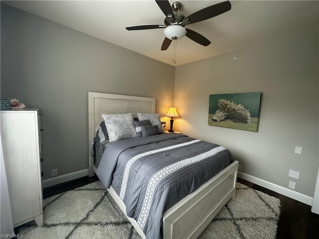 Bedroom featuring baseboards, ceiling fan, and wood finished floors