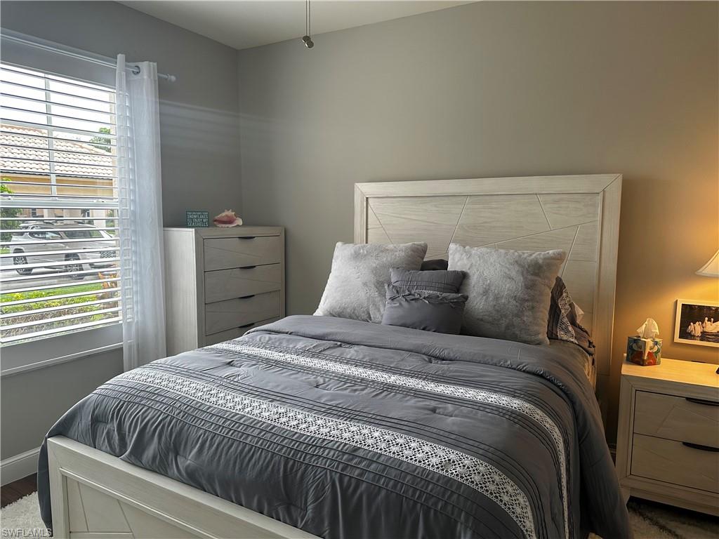 Bedroom featuring baseboards and wood finished floors