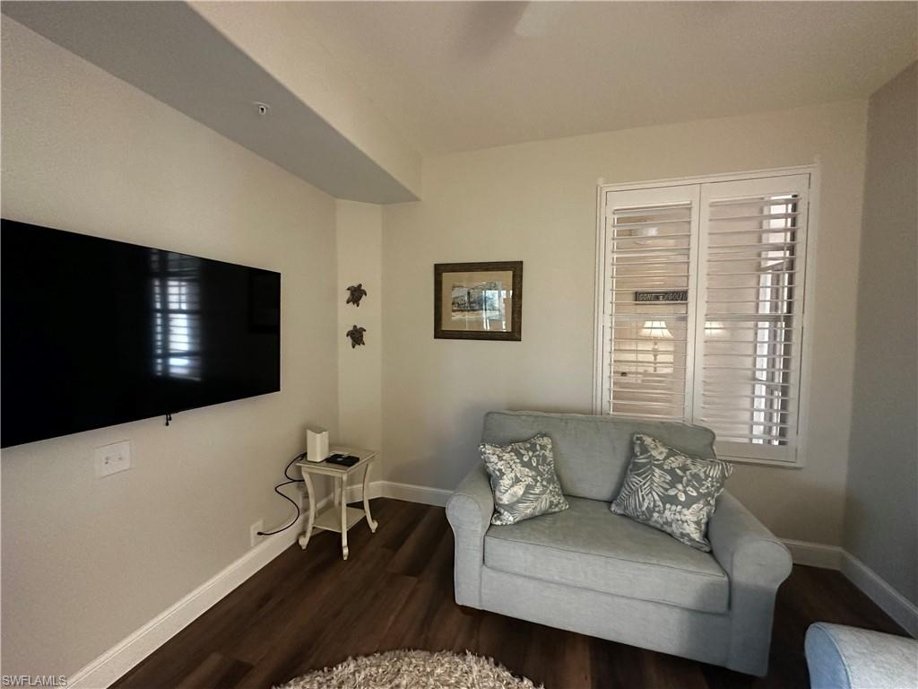 Sitting room featuring baseboards and wood finished floors